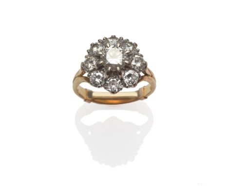 A Diamond Cluster Ring, a central round brilliant cut diamond surrounded by eight smaller diamonds, in white claw settings, t