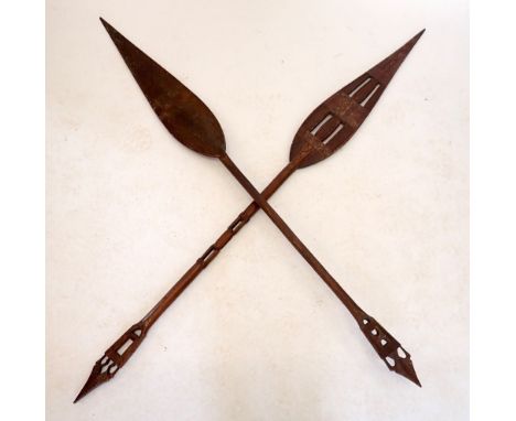 Two African carved wood ceremonial tribal spears, 158cm tall