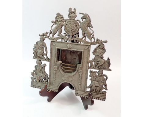 A late Victorian cast metal miniature model of fire grate with Royal Armorial crest over four classical female figures flanki