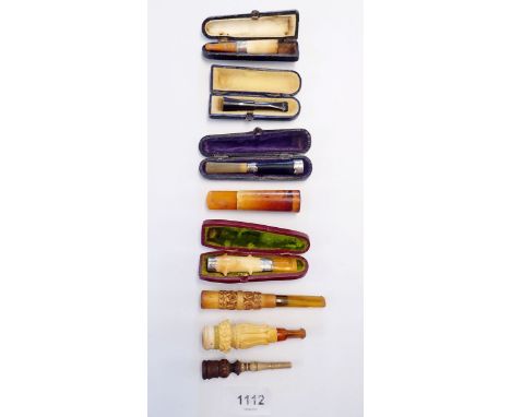 A collection of eight various cigar, cigarette and cheroot holders, mostley meerschaum or amber, three with silver collars an