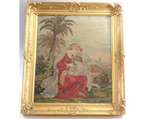 A 19th century large tapestry picture of woman feeding child in landscape with palm tree 54 x 44cm with gilt frame 