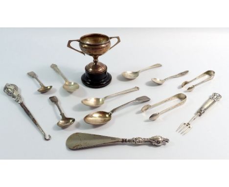 A group of silver cutlery, shoe horn, cake fork, trophy cup etc, 144g weighable silver