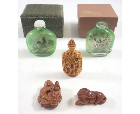 Two carved Japanese wooden netsuke of horse and seated figure plus two reverse painted glass snuff bottles and one other snuf