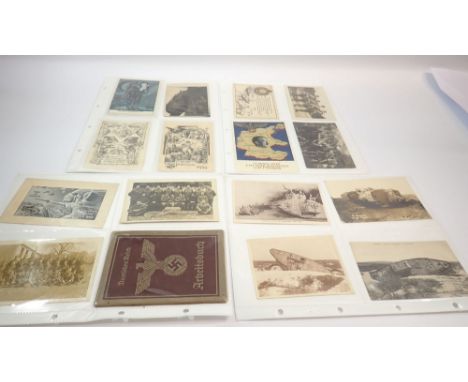 A postcard album of 28 military postcards of WWI and WWII interest including silk with tanks, Adolf Hitler at 1936 Olympics e