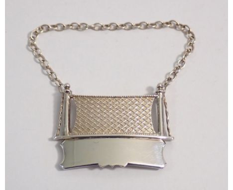 A silver decanter label in the form of a tennis net, 21g, London 2003 by PLG