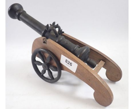 A model of a cast brass cannon bearing the mark VOC for the Dutch India Company mounted on an oak carriage with iron wheels, 