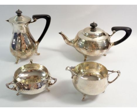 A Charles Edwards Arts &amp; Crafts silver four piece tea service comprising teapot, coffee pot, milk jug and sugar with sinu