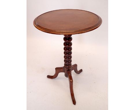 A 19th century mahogany wine table on turned bobbin column and triple supports, 44cm diameter
