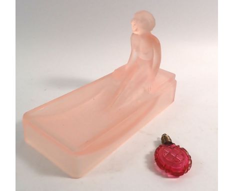 An Art Deco pink glass soap dish in the form of a  nude in bath tub 16cm long, plus a cut glass scent bottle