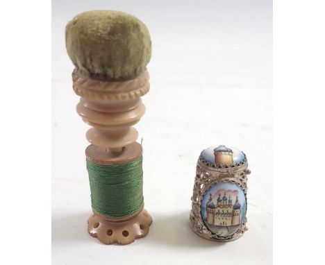 A white metal filligree and enamel thimble painted temple and a vegetable ivory pincushion and needlecase 