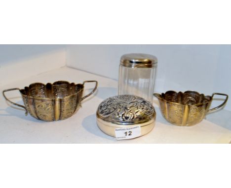 A silver mounted facetted dressing table jar;  an oval trinket box and cover, embossed with flowers and foliage;  a plated cr