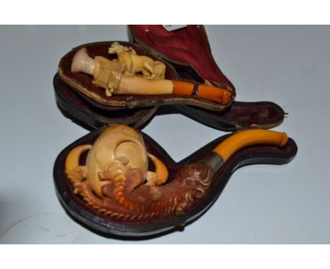 A 19th century meerschaum pipe, carved as a dragon's claws, the silver coloured metal mount dated 1887, cased; another, carve