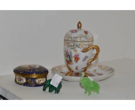 A French oval gilt metal mounted trinket box and cover, decorated with a fanciful bird with a gilt scroll cartouche on a coba