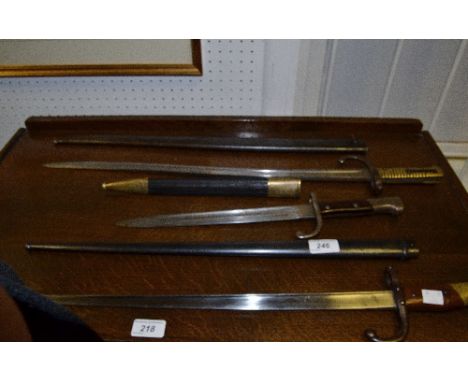 A Chassepot bayonet and scabbard, 84458 an Etienne spike bayonet and scabbard;  a Solingen dagger bayonet and scabbard (3)