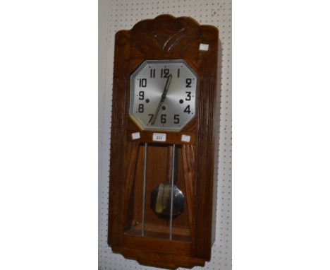 An oak Art Deco style pendulum wall clock