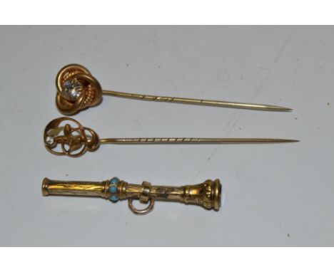 A 19th century gilt metal toothpick fob; two stick pins (3)