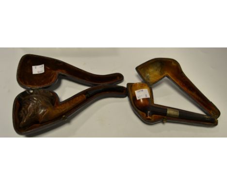 A Victorian silver mounted pipe, Birmingham 1897, cased; another, carved as the turbaned Jacob, cased (2)
