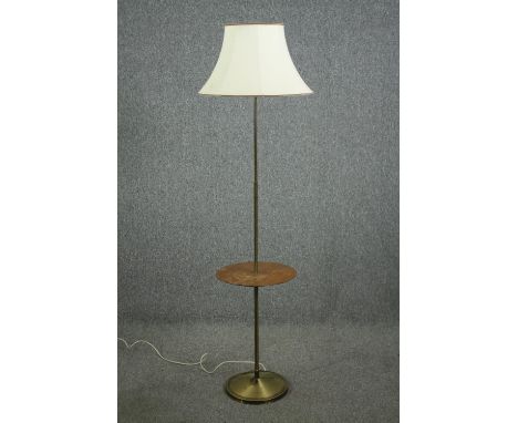 A mid 20th century brass and teak standard lamp. H.172cm. 