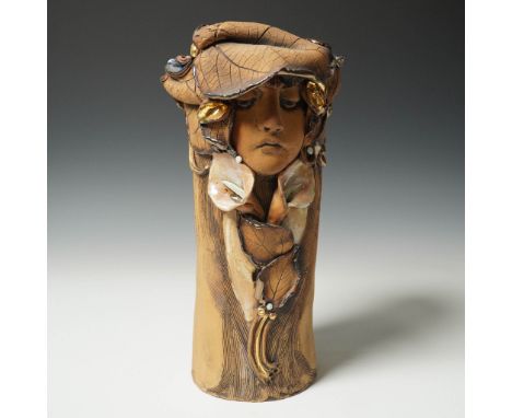 This handcrafted ceramic vase by artist Julie Morrison features a stylized female bust in high relief, seamlessly integrated 