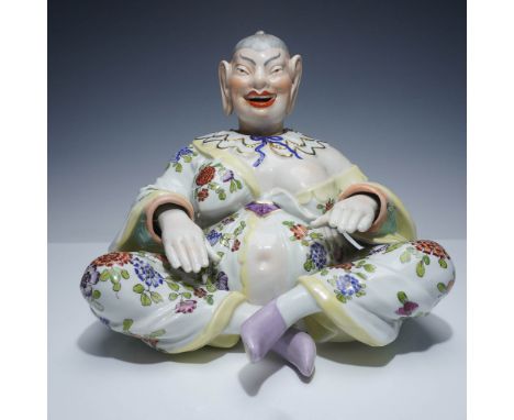 This captivating figural sculpture of a Pagoda depicts it seated in a flowing robe adorned with a profusion of colorful bloss