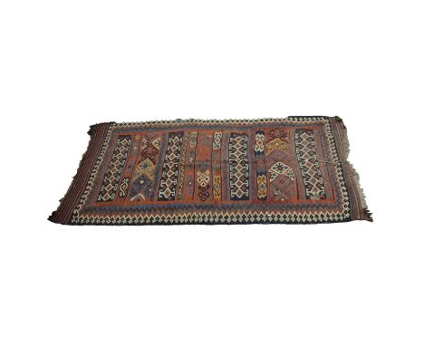 Five assorted rugs, all as found, including:Kelim rug, torn and with holes, 290x155cm; Shirvan rug, four medallions, multiple