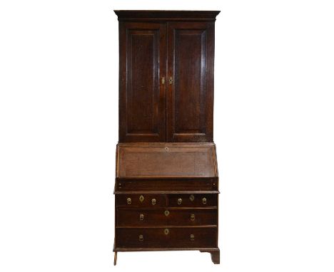 Georgian oak bureau bookcase, the top with moulded cornice, two panelled doors enclosing shelves, the base with fall front en