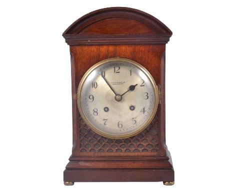 Edwardian mahogany mantel clock, Finnigans Ltd, Manchester, domed top, blind fretwork panel below the circular silvered dial,