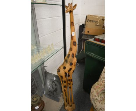 A large carved wood model of a giraffe.