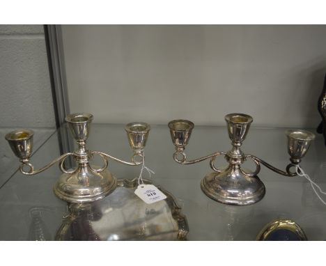 A pair of silver twin branch three light candelabra.
