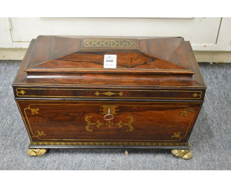 A very good Regency brass inlaid rosewood sarcophagus form tea caddy with fitted interior.