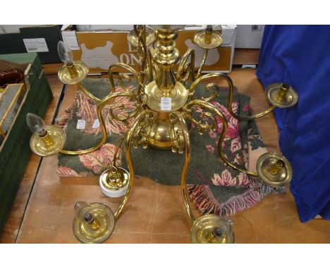 A brass chandelier and a throw.