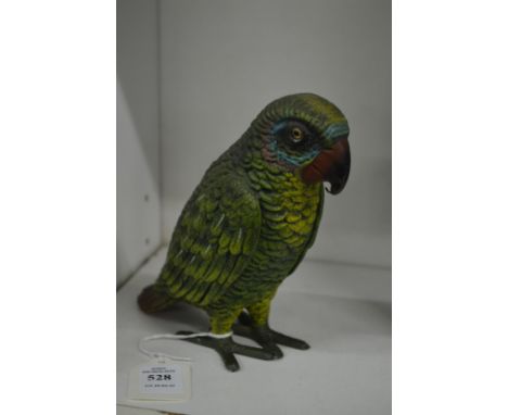 A painted spelter model of a parrot.