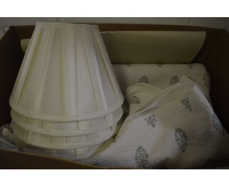 An Oka throw and set of four pleated lamp shades.