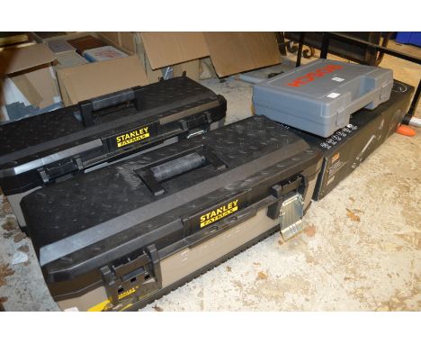 A Bosch cordless drill, two work boxes containing various tools, a trolley jack and other items.