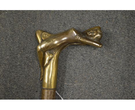 A walking stick, the brass handle modelled as a reclining female figure.