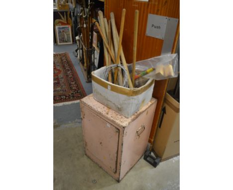 Croquet equipment and an old tin storage cabinet.