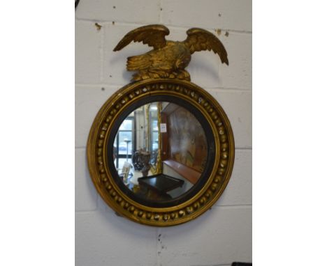 A Regency convex mirror with eagle mount.
