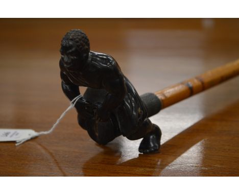 An unusual walking stick, the handle modelled as a man beating a drum.