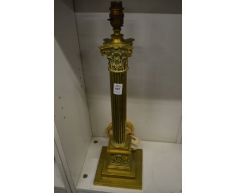 A brass corinthian column table lamp.