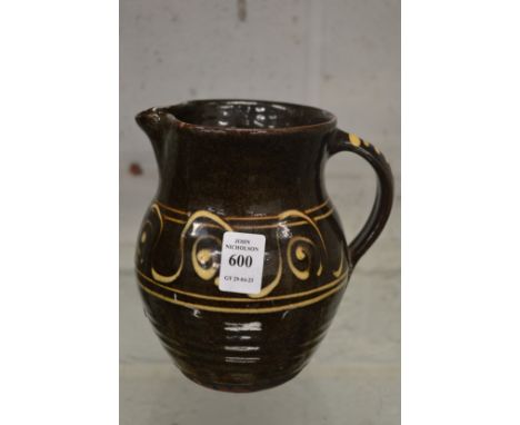 Michael Cardew, Winchcombe Pottery, a slip ware jug with impressed mark.
