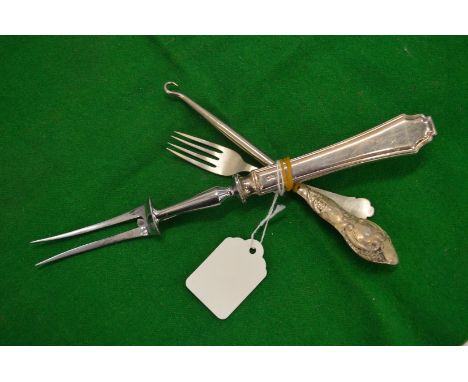 Silver fork, silver handled carving fork and a button hook.