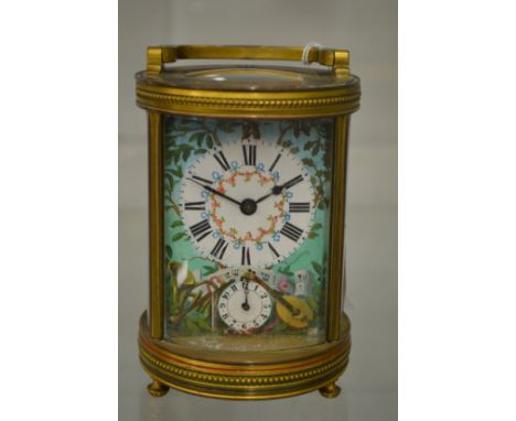 A good circular brass carriage clock with enamel decorated dial and case.