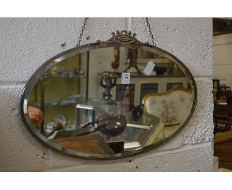 An oval wall mirror.