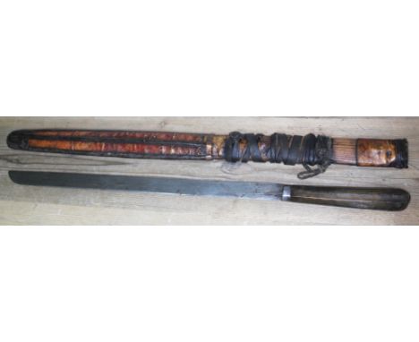 A Bhutanese Himalayan sword with horn handle, leather bound and metal mounted wooden scabbard, length 96cm.  