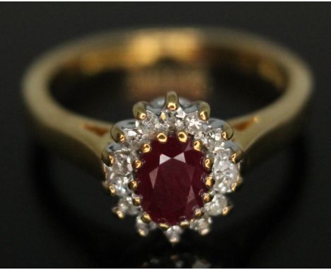 A diamond and ruby cluster ring, the cluster measuring approx. 9mm x 7mm, hallmarked 18ct gold, gross wt. 3.75g, size J.  