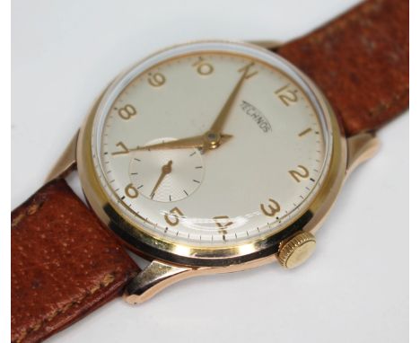 A vintage 1960s gold plated Technos wristwatch with signed champagne dial having Arabic numerals and dauphine hands in gold a