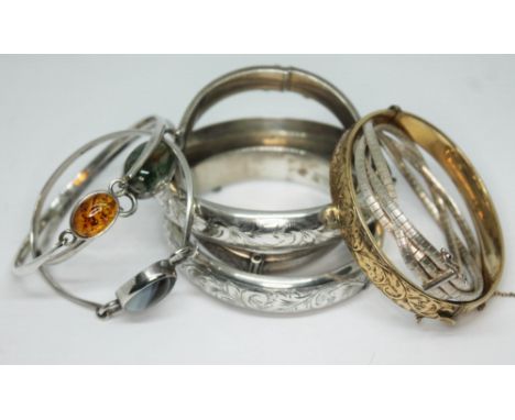A quantity of bangles comprising two hallmarked Scottish silver; one set with moss agate and the other with onyx, another sim