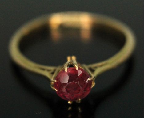 An Edwardian ring set with a round mixed cut pinkish red tourmaline weighing approx. 0.53ct, band marked '18ct', gross wt. 1.
