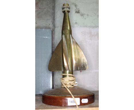 A brass table lamp formed as a propeller on round wooden base, height to top of bulb fitting 38cm.  
