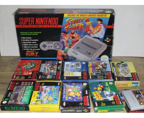 A Super Nintendo Entertainment System Street Fighter II console and various games.  